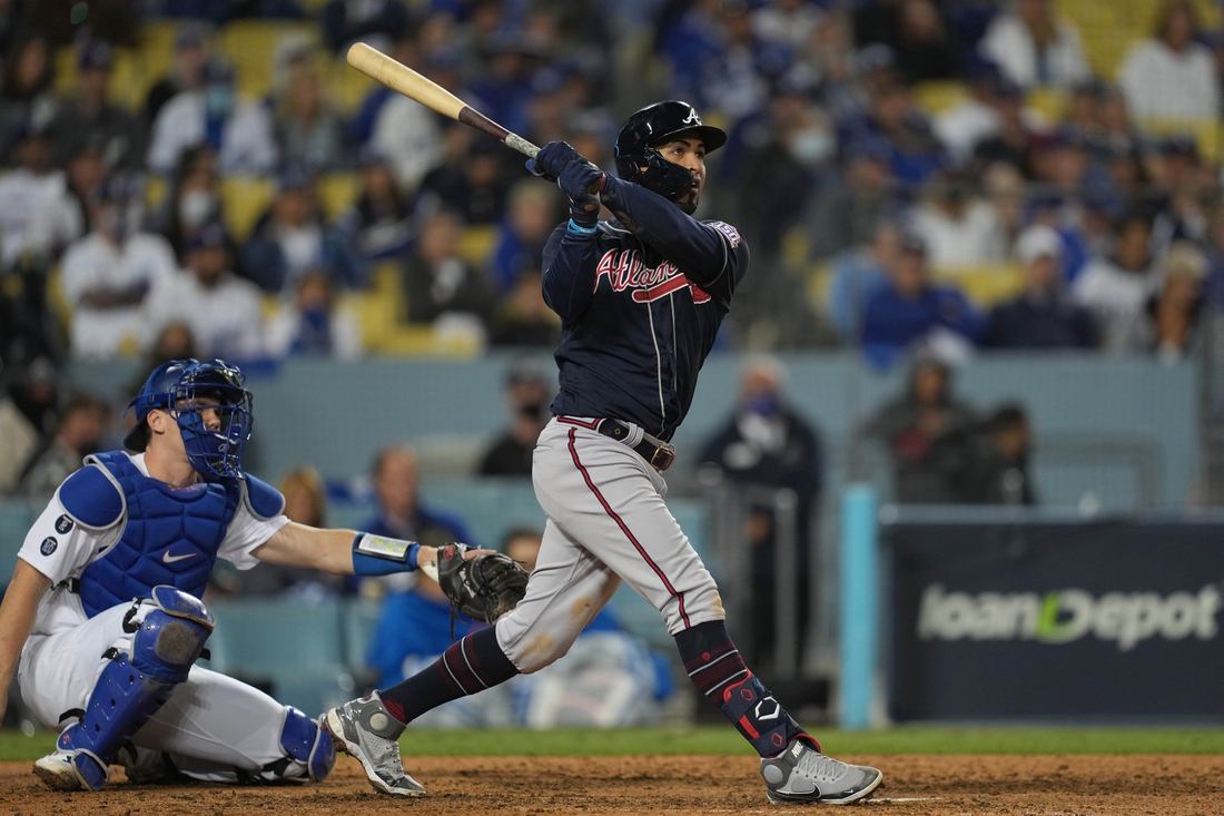 Oct 20, 2021; Los Angeles, California, USA; Atlanta Braves left fielder Eddie Rosario (8) hits a three run home run in the ninth inning against the Los Angeles Dodgers during game four of the 2021 NLCS at Dodger Stadium. Mandatory Credit: Kirby Lee-USA TODAY Sports