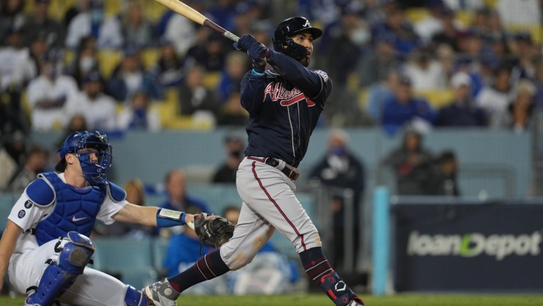 Oct 20, 2021; Los Angeles, California, USA; Atlanta Braves left fielder Eddie Rosario (8) hits a three run home run in the ninth inning against the Los Angeles Dodgers during game four of the 2021 NLCS at Dodger Stadium. Mandatory Credit: Kirby Lee-USA TODAY Sports