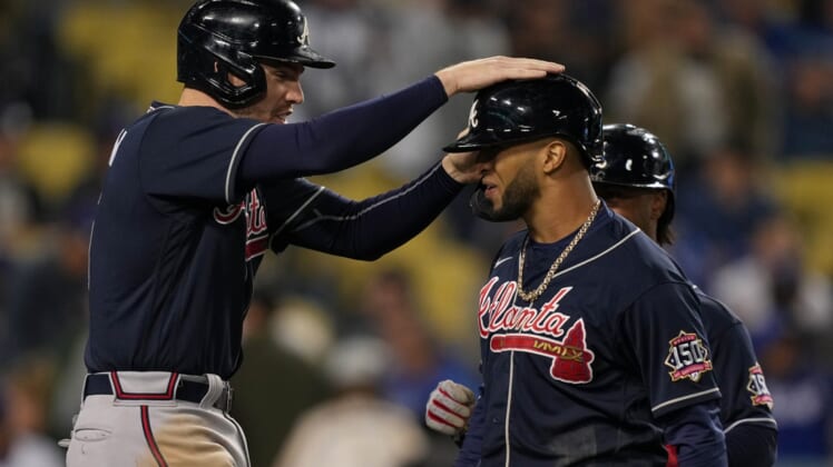 Oct 20, 2021; Los Angeles, California, USA; Atlanta Braves first baseman Freddie Freeman (5) celebrates scoring on a three run home run by left fielder Eddie Rosario (8) in the ninth inning against the Los Angeles Dodgers during game four of the 2021 NLCS at Dodger Stadium. Mandatory Credit: Kirby Lee-USA TODAY Sports