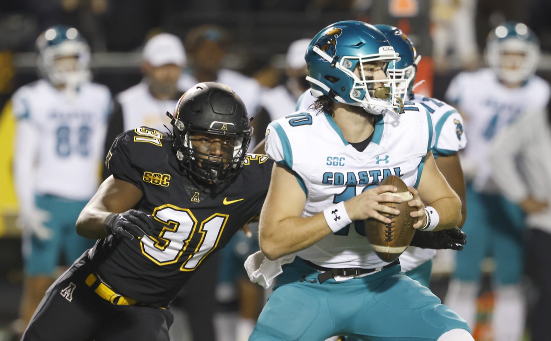 Oct 20, 2021; Boone, North Carolina, USA; Appalachian State Mountaineers linebacker Nick Hampton (31) catches Coastal Carolina Chanticleers quarterback Grayson McCall (10) and sacks him during the second half at Kidd Brewer Stadium. Mandatory Credit: Reinhold Matay-USA TODAY Sports