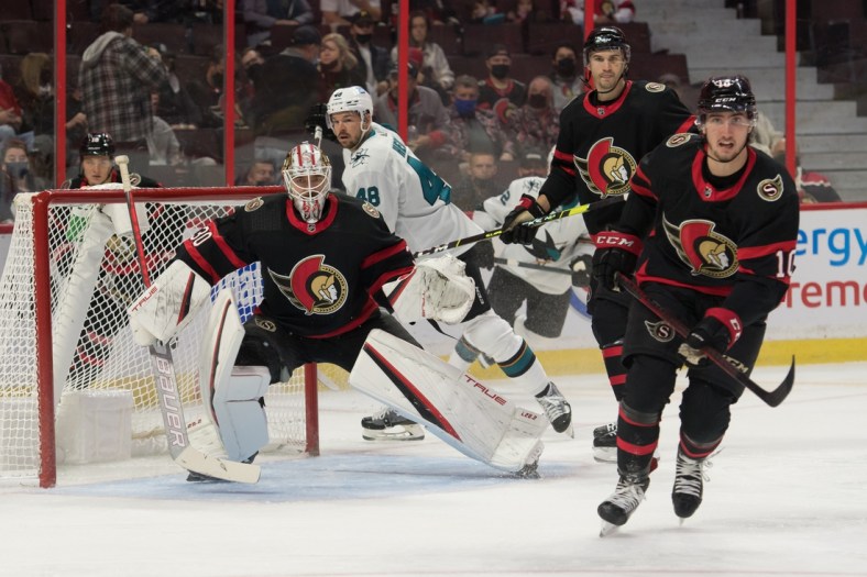 Oct 21, 2021; Ottawa, Ontario, CAN; Ottawa Senators goalie Matt Murray (30) defeseman Josh Brown (3) and left wing Alex Formenton (10) follow the puck in the first period against the San Jose Sharks at the Canadian Tire Centre. Mandatory Credit: Marc DesRosiers-USA TODAY Sports