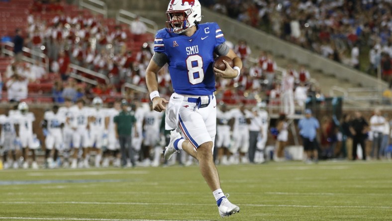 Oct 21, 2021; Dallas, Texas, USA; Southern Methodist Mustangs quarterback Tanner Mordecai (8) runs for a touchdown in the first quarter against the Tulane Green Wave at Gerald J. Ford Stadium. Mandatory Credit: Tim Heitman-USA TODAY Sports