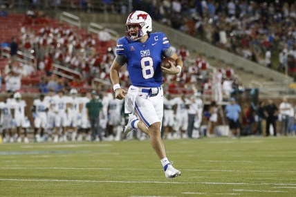 Oct 21, 2021; Dallas, Texas, USA; Southern Methodist Mustangs quarterback Tanner Mordecai (8) runs for a touchdown in the first quarter against the Tulane Green Wave at Gerald J. Ford Stadium. Mandatory Credit: Tim Heitman-USA TODAY Sports