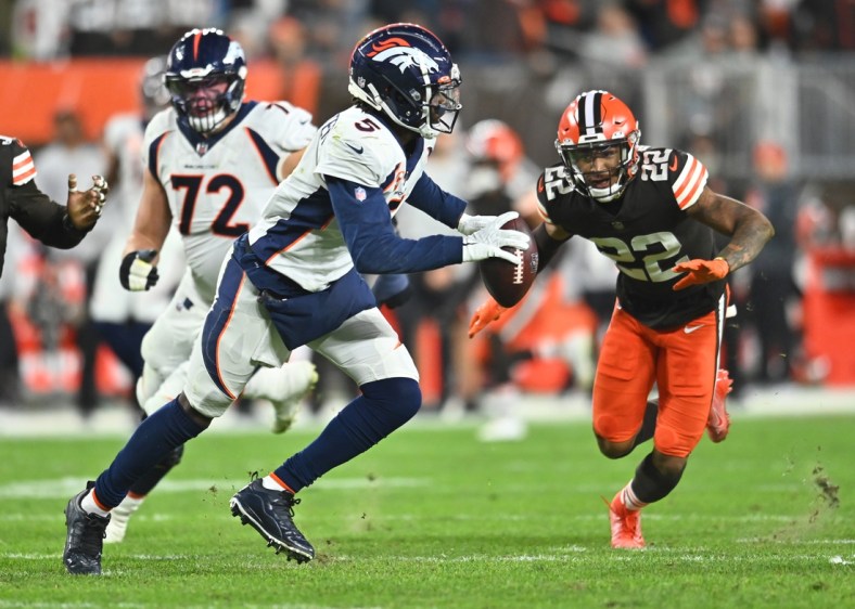 Oct 21, 2021; Cleveland, Ohio, USA; Denver Broncos quarterback Teddy Bridgewater (5) scrambles from Cleveland Browns defensive back Grant Delpit (22) during the first half at FirstEnergy Stadium. Mandatory Credit: Ken Blaze-USA TODAY Sports