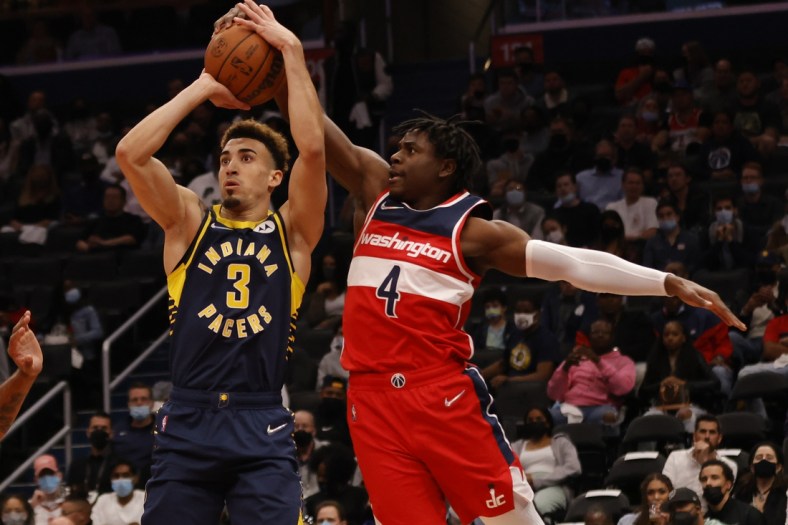 Oct 22, 2021; Washington, District of Columbia, USA; Washington Wizards guard Aaron Holiday (4) blocks the shot of Indiana Pacers guard Chris Duarte (3) during the first quarter at Capital One Arena. Mandatory Credit: Geoff Burke-USA TODAY Sports