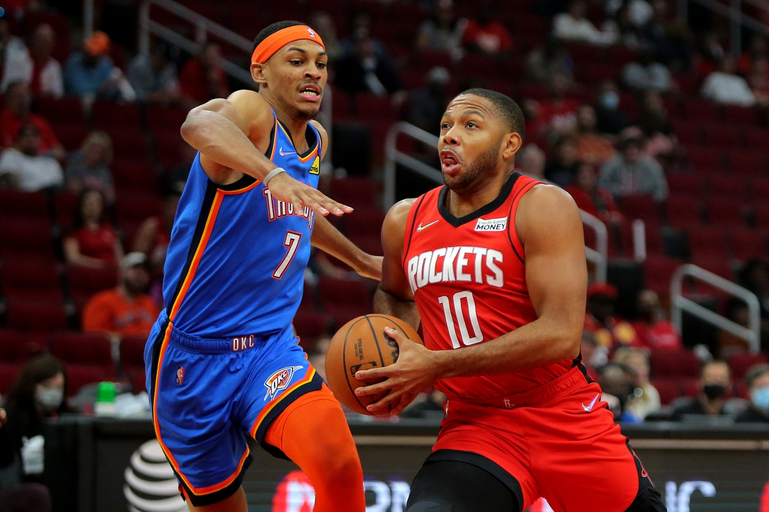 Oct 22, 2021; Houston, Texas, USA; Houston Rockets guard Eric Gordon (10, right) drives to the basket while Oklahoma City Thunder forward Darius Bazley (7, left) defends during the first quarter at Toyota Center. Mandatory Credit: Erik Williams-USA TODAY Sports