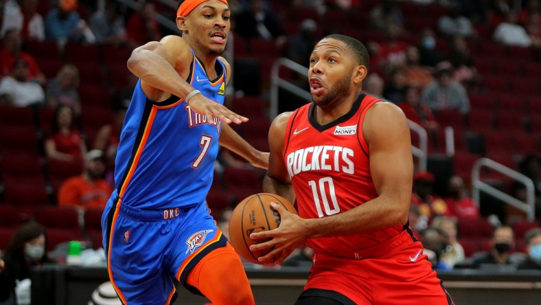 Oct 22, 2021; Houston, Texas, USA; Houston Rockets guard Eric Gordon (10, right) drives to the basket while Oklahoma City Thunder forward Darius Bazley (7, left) defends during the first quarter at Toyota Center. Mandatory Credit: Erik Williams-USA TODAY Sports