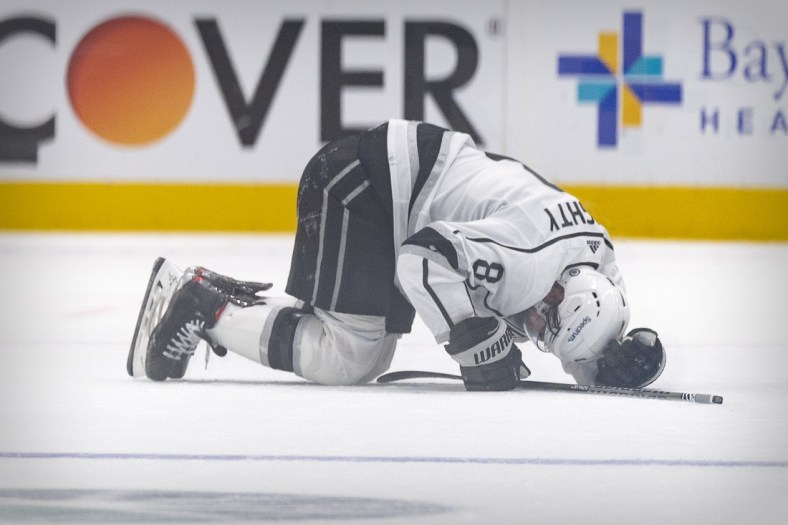 Oct 22, 2021; Dallas, Texas, USA; Los Angeles Kings defenseman Drew Doughty (8) lies on the ice after getting injured on a hit by Dallas Stars defenseman Jani Hakanpaa (not pictured) during the second period at the American Airlines Center. Mandatory Credit: Jerome Miron-USA TODAY Sports