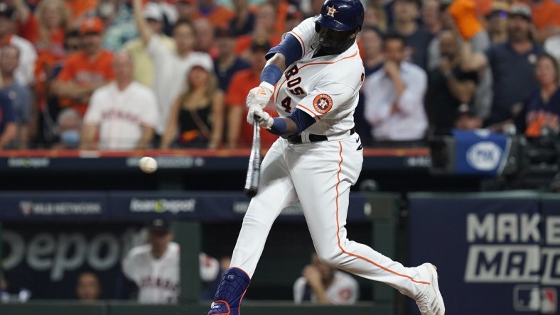 Oct 22, 2021; Houston, Texas, USA; Houston Astros designated hitter Yordan Alvarez (44) hits a triple in the sixth inning against the Boston Red Sox during game six of the 2021 ALCS at Minute Maid Park. Mandatory Credit: Thomas Shea-USA TODAY Sports