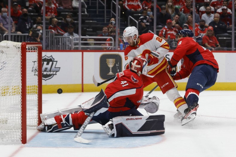 Oct 23, 2021; Washington, District of Columbia, USA; Calgary Flames center Elias Lindholm (28) scores a goal on Washington Capitals goaltender Vitek Vanecek (41) during the first period at Capital One Arena. Mandatory Credit: Geoff Burke-USA TODAY Sports
