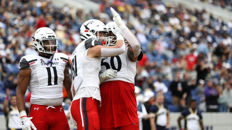 UC's Josh Whyle (81) celebrates with the team after scoring another touchdown during the second half of the UC Bearcat vs. Navy Midshipmen game at Navy-Marine Corps Memorial Stadium on Saturday October 23, 2021. UC won the game with a final score of 27-20.