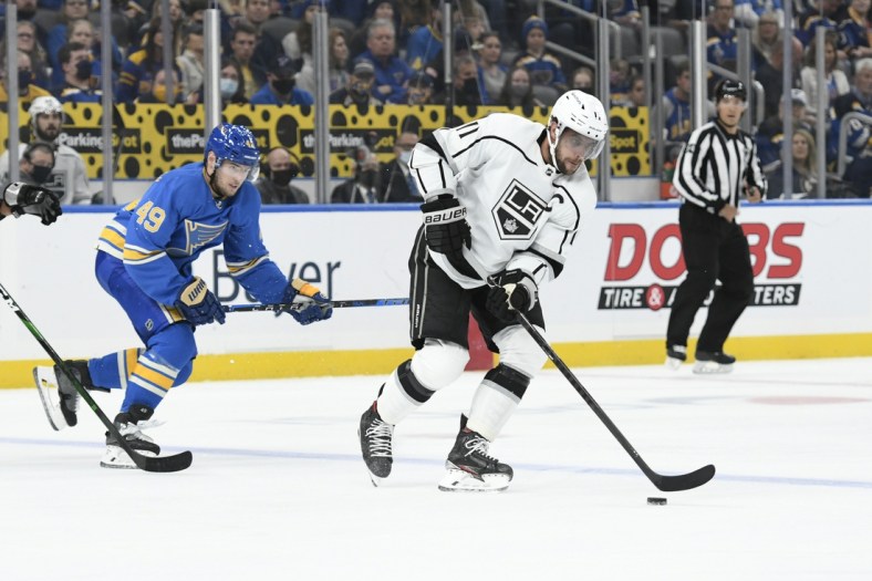 Oct 23, 2021; St. Louis, Missouri, USA; Los Angeles Kings center Anze Kopitar (11) controls the puck from St. Louis Blues center Ivan Barbashev (49) in the first period at Enterprise Center. Mandatory Credit: Jeff Le-USA TODAY Sports