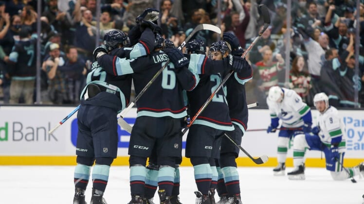 Oct 23, 2021; Seattle, Washington, USA; Seattle Kraken defenseman Vince Dunn (29) celebrates with teammates after scoring a goal against the Vancouver Canucks during the first period at Climate Pledge Arena. Mandatory Credit: Joe Nicholson-USA TODAY Sports