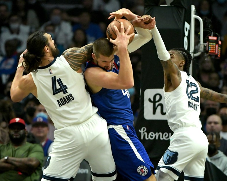 Oct 23, 2021; Los Angeles, California, USA;  Los Angeles Clippers center Ivica Zubac (40) fights off Memphis Grizzlies center Steven Adams (4) and Memphis Grizzlies guard Ja Morant (12) for a rebound in the first quarter of the game at Staples Center. Mandatory Credit: Jayne Kamin-Oncea-USA TODAY Sports