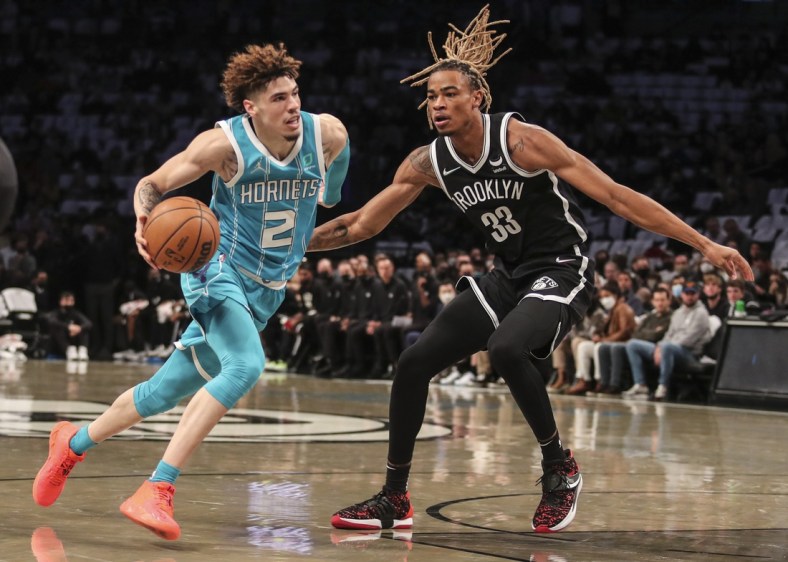 Oct 24, 2021; Brooklyn, New York, USA;  Charlotte Hornets guard LaMelo Ball (2) drives past Brooklyn Nets forward Nic Claxton (33) in the first quarter at Barclays Center. Mandatory Credit: Wendell Cruz-USA TODAY Sports