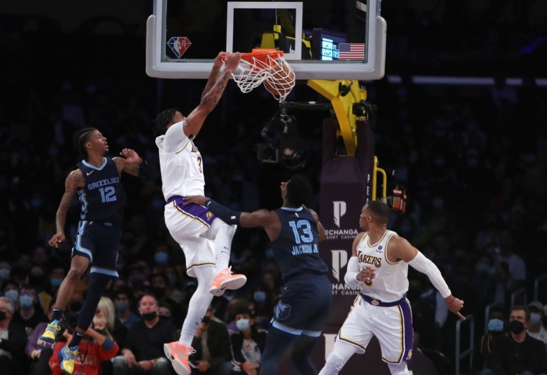 Oct 24, 2021; Los Angeles, California, USA; Los Angeles Lakers forward Anthony Davis (3) dunks over Memphis Grizzlies forward Jaren Jackson Jr. (13) during the first quarter at Staples Center. Mandatory Credit: Kiyoshi Mio-USA TODAY Sports