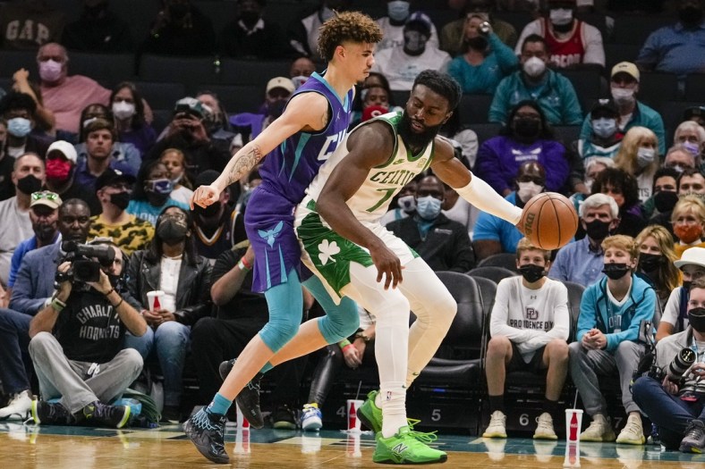 Oct 25, 2021; Charlotte, North Carolina, USA; Charlotte Hornets guard LaMelo Ball (2) defends Boston Celtics guard Jaylen Brown (7) during the first period at the Spectrum Center. Mandatory Credit: Jim Dedmon-USA TODAY Sports