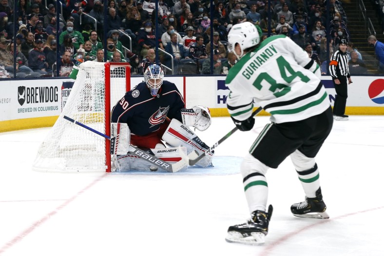 Oct 25, 2021; Columbus, Ohio, USA; Columbus Blue Jackets goalie Elvis Merzlikins (90) tracks the shot from Dallas Stars right wing Denis Gurianov (34) during the first period at Nationwide Arena. Mandatory Credit: Russell LaBounty-USA TODAY Sports