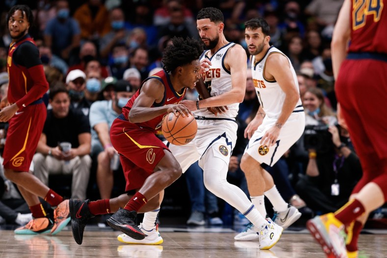Oct 25, 2021; Denver, Colorado, USA; Cleveland Cavaliers guard Collin Sexton (2) dribbles the ball as Denver Nuggets guard Austin Rivers (25) defends in the second quarter at Ball Arena. Mandatory Credit: Isaiah J. Downing-USA TODAY Sports