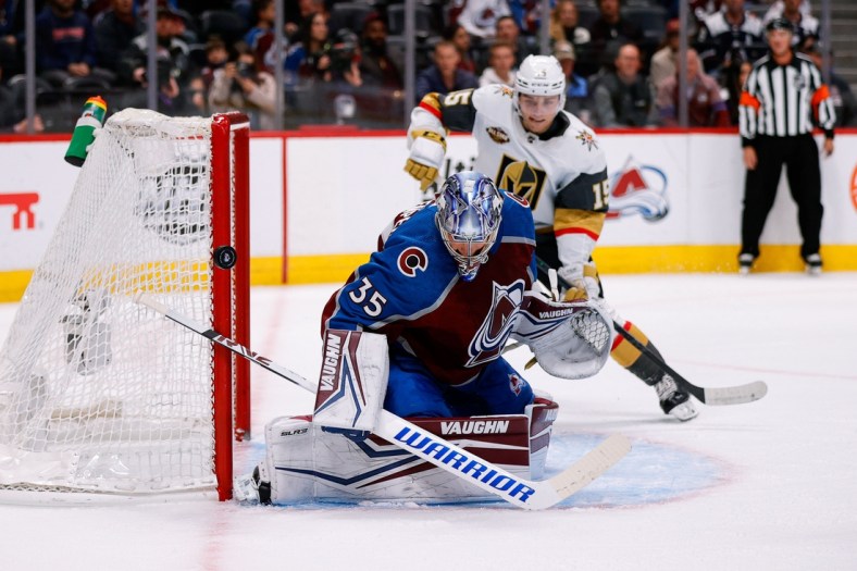 Oct 26, 2021; Denver, Colorado, USA; Colorado Avalanche goaltender Darcy Kuemper (35) deflects the puck ahead of Vegas Golden Knights center Jake Leschyshyn (15) in the first period at Ball Arena. Mandatory Credit: Isaiah J. Downing-USA TODAY Sports