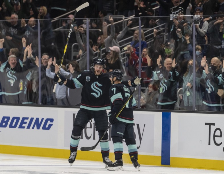 Oct 26, 2021; Seattle, Washington, USA;  Seattle Kraken defenseman Jamie Oleksiak (24) and right wing Jordan Eberle (7) celebrate a goal during the first period against the Montreal Canadiens at Climate Pledge Arena. Mandatory Credit: Stephen Brashear-USA TODAY Sports