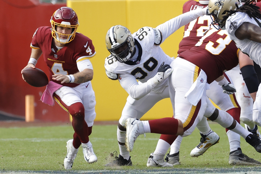 Oct 10, 2021; Landover, Maryland, USA; Washington Football Team quarterback Taylor Heinicke (4) scrambles against the New Orleans Saints at FedExField. Mandatory Credit: Geoff Burke-USA TODAY Sports