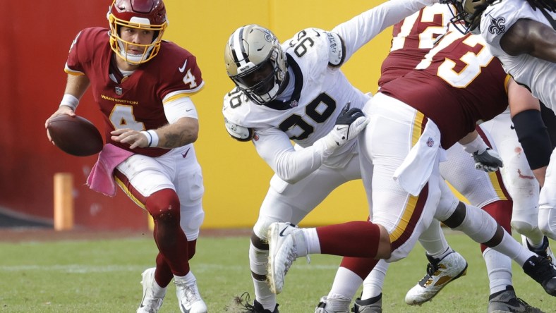 Oct 10, 2021; Landover, Maryland, USA; Washington Football Team quarterback Taylor Heinicke (4) scrambles against the New Orleans Saints at FedExField. Mandatory Credit: Geoff Burke-USA TODAY Sports