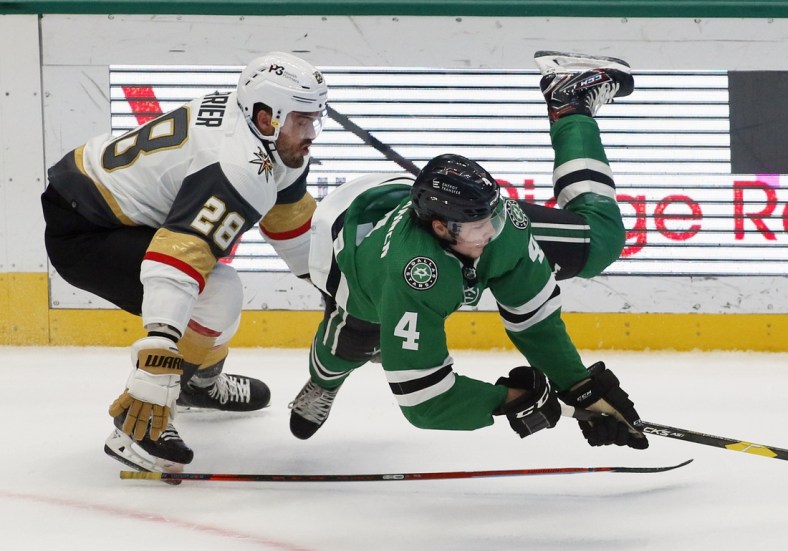 Oct 27, 2021; Dallas, Texas, USA; Dallas Stars defenseman Miro Heiskanen (4) picks up the tripping penalty on Vegas Golden Knights left wing William Carrier (28) during the first period at American Airlines Center. Mandatory Credit: Raymond Carlin III-USA TODAY Sports