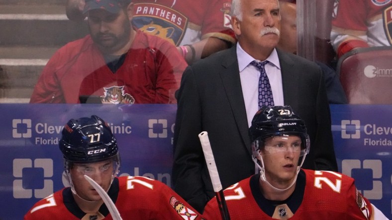 Oct 27, 2021; Sunrise, Florida, USA; Florida Panthers head coach Joel Quenneville watches from behind the bench during the first period between the Florida Panthers and the Boston Bruins at FLA Live Arena. Mandatory Credit: Jasen Vinlove-USA TODAY Sports