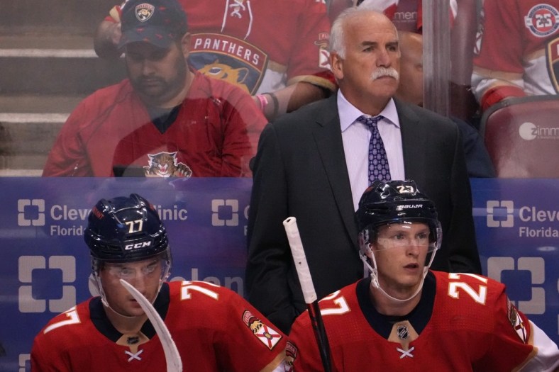Oct 27, 2021; Sunrise, Florida, USA; Florida Panthers head coach Joel Quenneville watches from behind the bench during the first period between the Florida Panthers and the Boston Bruins at FLA Live Arena. Mandatory Credit: Jasen Vinlove-USA TODAY Sports