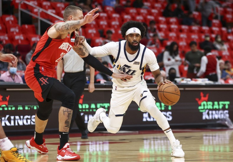 Oct 28, 2021; Houston, Texas, USA; Utah Jazz guard Mike Conley (11) dribbles the ball as Houston Rockets center Daniel Theis (27) defends during the first quarter at Toyota Center. Mandatory Credit: Troy Taormina-USA TODAY Sports