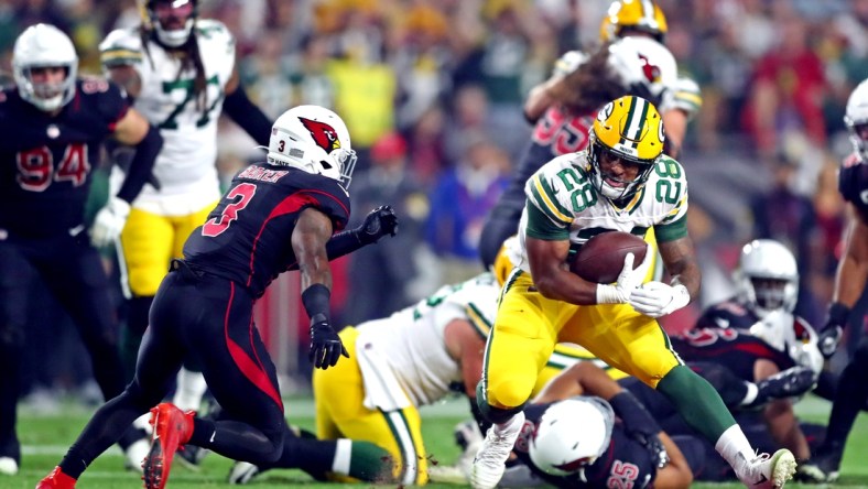 Oct 28, 2021; Glendale, Arizona, USA; Green Bay Packers running back A.J. Dillon (28) runs the ball against Arizona Cardinals safety Budda Baker (3) during the first half at State Farm Stadium. Mandatory Credit: Mark J. Rebilas-USA TODAY Sports