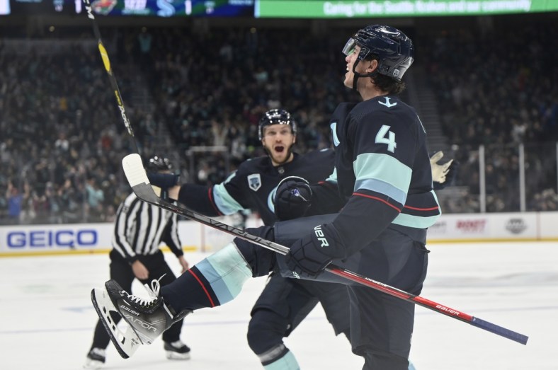 Oct 28, 2021; Seattle, Washington, USA; Seattle Kraken defenseman Haydn Fleury (4) celebrates after scoring a goal against the Minnesota Wild during the second period at Climate Pledge Arena. Mandatory Credit: Steven Bisig-USA TODAY Sports