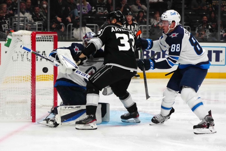 Oct 28, 2021; Los Angeles, California, USA; Winnipeg Jets goaltender Eric Comrie (1) and defenseman Nate Schmidt (88) defend the goal against LA Kings right wing Viktor Arvidsson (33) in the second period at Staples Center. Mandatory Credit: Kirby Lee-USA TODAY Sports