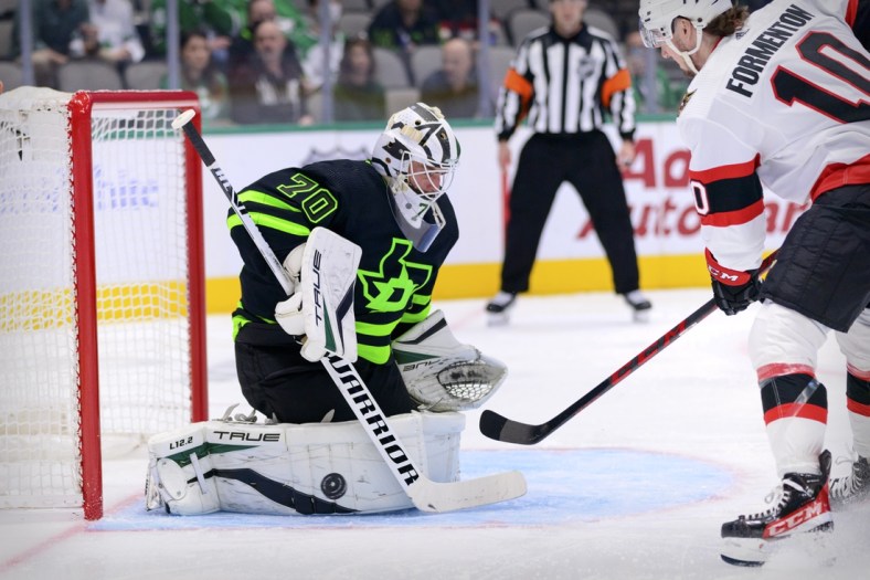 Oct 29, 2021; Dallas, Texas, USA; Dallas Stars goaltender Braden Holtby (70) stops a shot by Ottawa Senators left wing Alex Formenton (10) during the first period at the American Airlines Center. Mandatory Credit: Jerome Miron-USA TODAY Sports