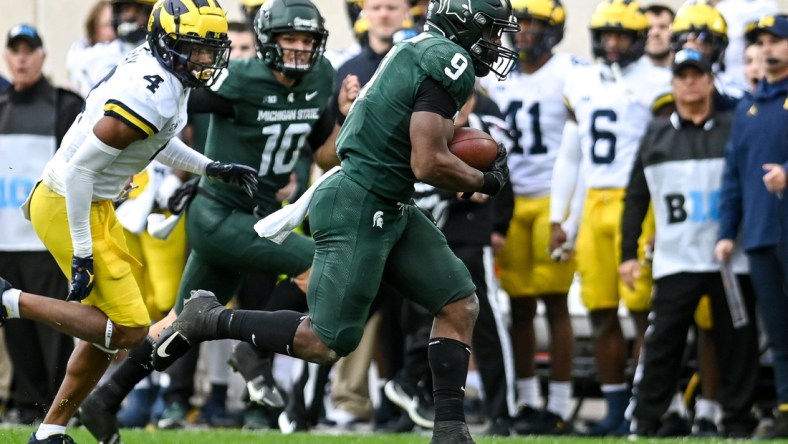 Michigan State's Kenneth Walker III, right, runs for a touchdown as Michigan's Vincent Gray trails behind during the second quarter on Saturday, Oct. 30, 2021, at Spartan Stadium in East Lansing.

211030 Msu Michigan 084a