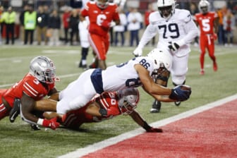 Oct 30, 2021; Columbus, Ohio, USA; Penn State Nittany Lions tight end Brenton Strange (86) dives in for the touchdown as Ohio State Buckeyes linebacker Teradja Mitchell (3)and linebacker Cody Simon (30)tackle him during the first quarter at Ohio Stadium. Mandatory Credit: Joseph Maiorana-USA TODAY Sports