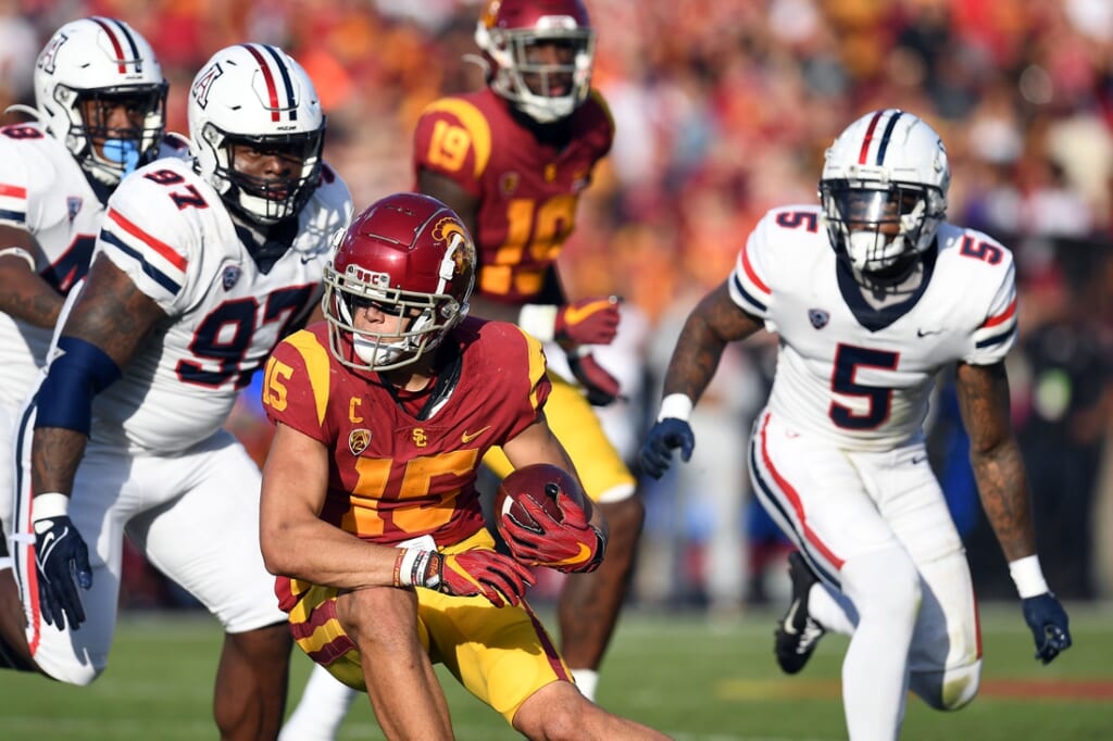 Oct 30, 2021; Los Angeles, California, USA; Southern California Trojans wide receiver Drake London (15) runs the ball ahead of Arizona Wildcats defensive lineman Leevel Tatum III (97) and linebacker Christian Young (5) during the first half at United Airlines Field at Los Angeles Memorial Coliseum. Mandatory Credit: Gary A. Vasquez-USA TODAY Sports
