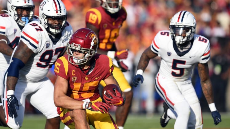 Oct 30, 2021; Los Angeles, California, USA; Southern California Trojans wide receiver Drake London (15) runs the ball ahead of Arizona Wildcats defensive lineman Leevel Tatum III (97) and linebacker Christian Young (5) during the first half at United Airlines Field at Los Angeles Memorial Coliseum. Mandatory Credit: Gary A. Vasquez-USA TODAY Sports