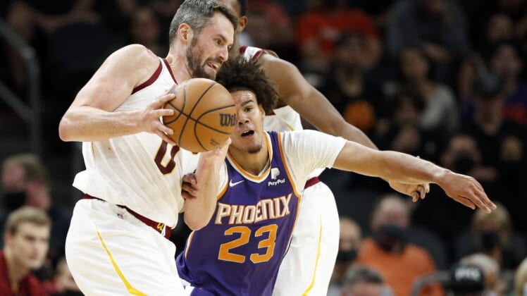 Oct 30, 2021; Phoenix, Arizona, USA; Phoenix Suns forward Cameron Johnson (23) battles for the ball against Cleveland Cavaliers forward Kevin Love (0) in the second quarter at Footprint Center. Mandatory Credit: Chris Coduto-USA TODAY Sports