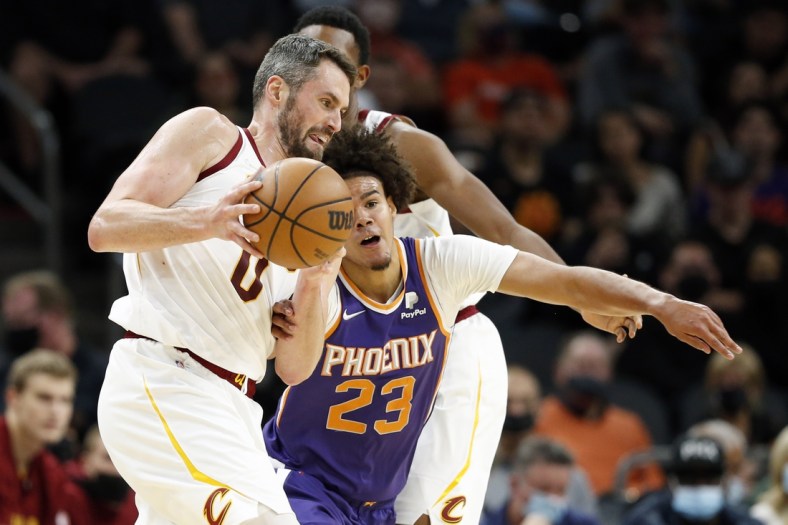 Oct 30, 2021; Phoenix, Arizona, USA; Phoenix Suns forward Cameron Johnson (23) battles for the ball against Cleveland Cavaliers forward Kevin Love (0) in the second quarter at Footprint Center. Mandatory Credit: Chris Coduto-USA TODAY Sports