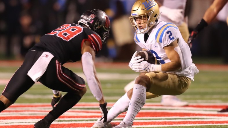 Oct 30, 2021; Salt Lake City, Utah, USA;  UCLA Bruins wide receiver Kyle Philips (2) is tackled by Utah Utes safety Brandon McKinney (28) during the first quarter at Rice-Eccles Stadium. Mandatory Credit: Rob Gray-USA TODAY Sports