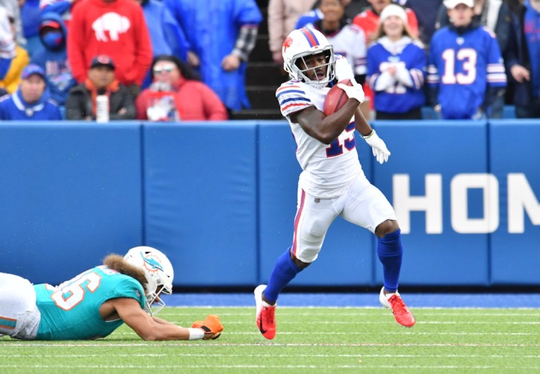 Oct 31, 2021; Orchard Park, New York, USA; Buffalo Bills wide receiver Isaiah McKenzie (19) runs by Miami Dolphins wide receiver Mack Hollins (86) on a punt return in the second quarter at Highmark Stadium. Mandatory Credit: Mark Konezny-USA TODAY Sports