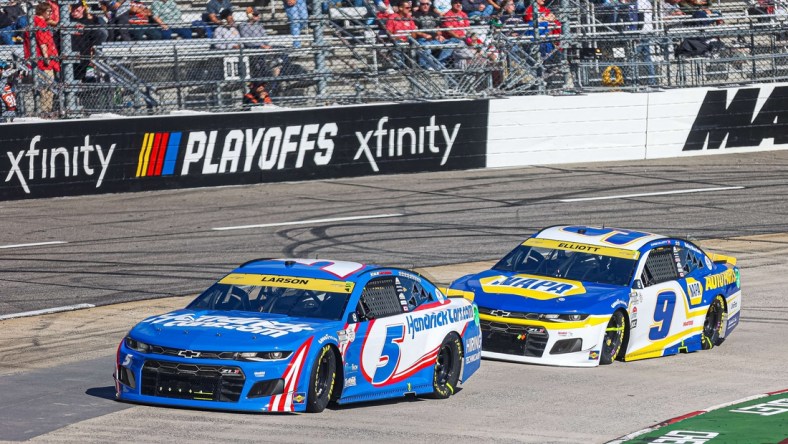 Oct 31, 2021; Martinsville, Virginia, USA; NASCAR Cup Series driver Kyle Larson (5) leads races Chase Elliott (9) at the 73rd Annual Xfinity 500 at Martinsville Speedway. Mandatory Credit: Ryan Hunt-USA TODAY Sports