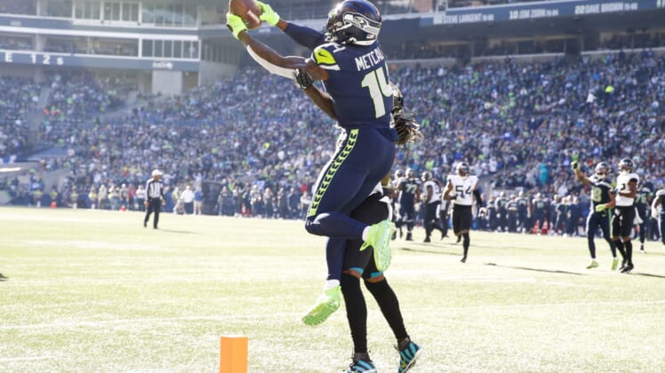 Oct 31, 2021; Seattle, Washington, USA; Seattle Seahawks wide receiver DK Metcalf (14) catches a touchdown pass against Jacksonville Jaguars cornerback Shaquill Griffin (26) during the second quarter at Lumen Field. Mandatory Credit: Joe Nicholson-USA TODAY Sports
