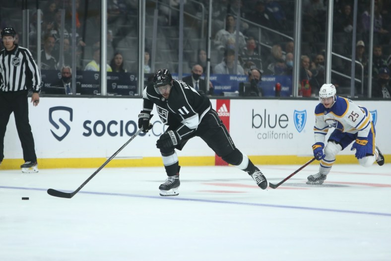 Oct 31, 2021; Los Angeles, California, USA; Los Angeles Kings center Anze Kopitar (11) chases the puck against Buffalo Sabres center Arttu Ruotsalainen (25) during the second period at Staples Center. Mandatory Credit: Kiyoshi Mio-USA TODAY Sports