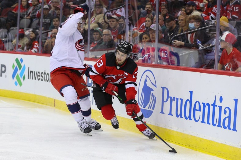 Oct 31, 2021; Newark, New Jersey, USA; New Jersey Devils center Nico Hischier (13) skates with the puck against the Columbus Blue Jackets during the second period at Prudential Center. Mandatory Credit: Ed Mulholland-USA TODAY Sports