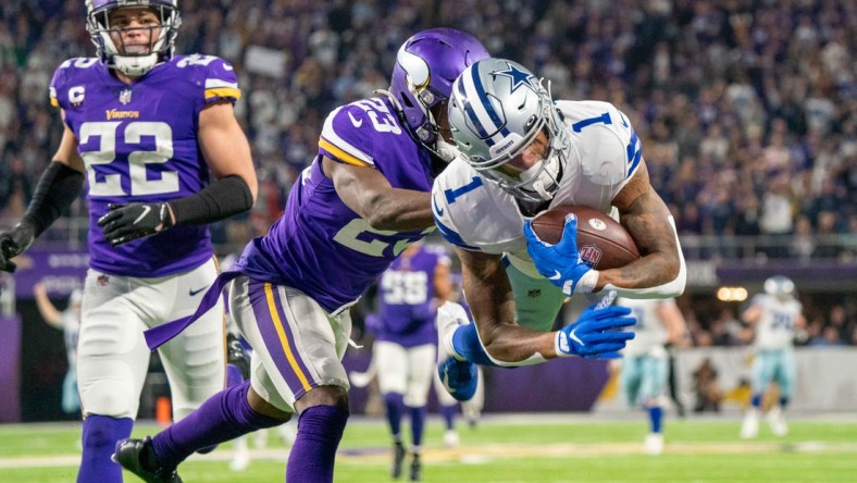 Oct 31, 2021; Minneapolis, Minnesota, USA; Dallas Cowboys wide receiver Ced Wilson (1) scores a touchdown in the third quarter as Minnesota Vikings free safety Xavier Woods (23) and safety Harrison Smith (22) defend at U.S. Bank Stadium. Mandatory Credit: Matt Blewett-USA TODAY Sports