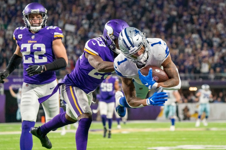 Oct 31, 2021; Minneapolis, Minnesota, USA; Dallas Cowboys wide receiver Ced Wilson (1) scores a touchdown in the third quarter as Minnesota Vikings free safety Xavier Woods (23) and safety Harrison Smith (22) defend at U.S. Bank Stadium. Mandatory Credit: Matt Blewett-USA TODAY Sports