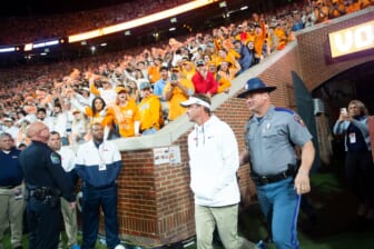 WATCH: Lane Kiffin hit by golf ball, Tennessee fans throw garbage on field